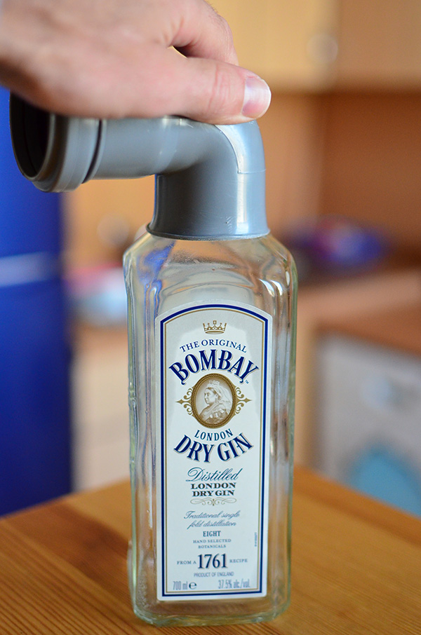Good old Bombay - the liquid is gone but the bottle still can be used - this is what I call usability. Preheat the knee on the stove and press firmly against the bottle's neck, now you have a bell flared throat opening.